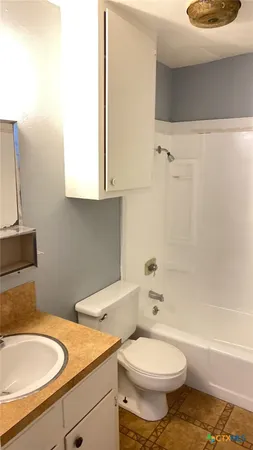 a bathroom with a sink a toilet and bathtub