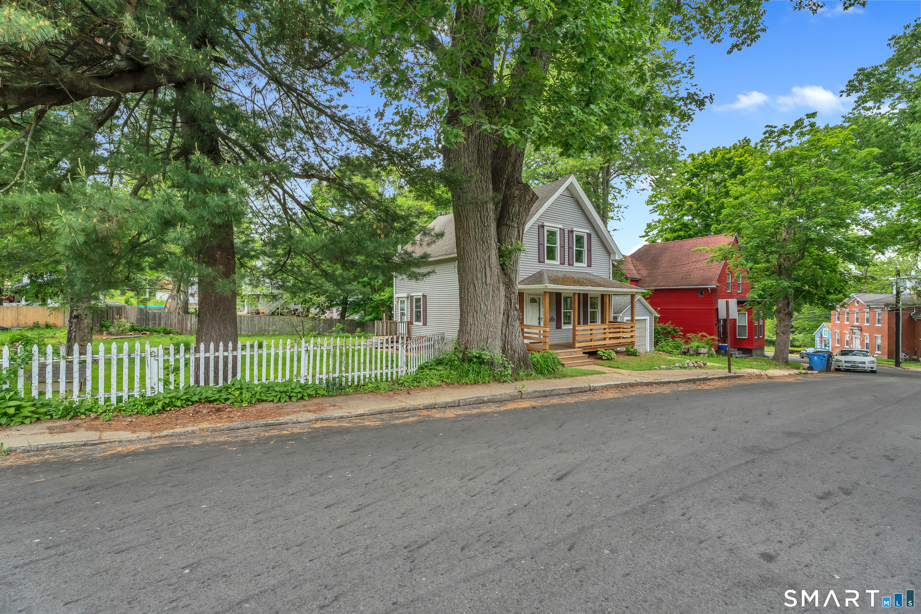 75 Summit Street Norwich, CT 06360 - Photo 35 of 40 a front view of a house with a garden and trees