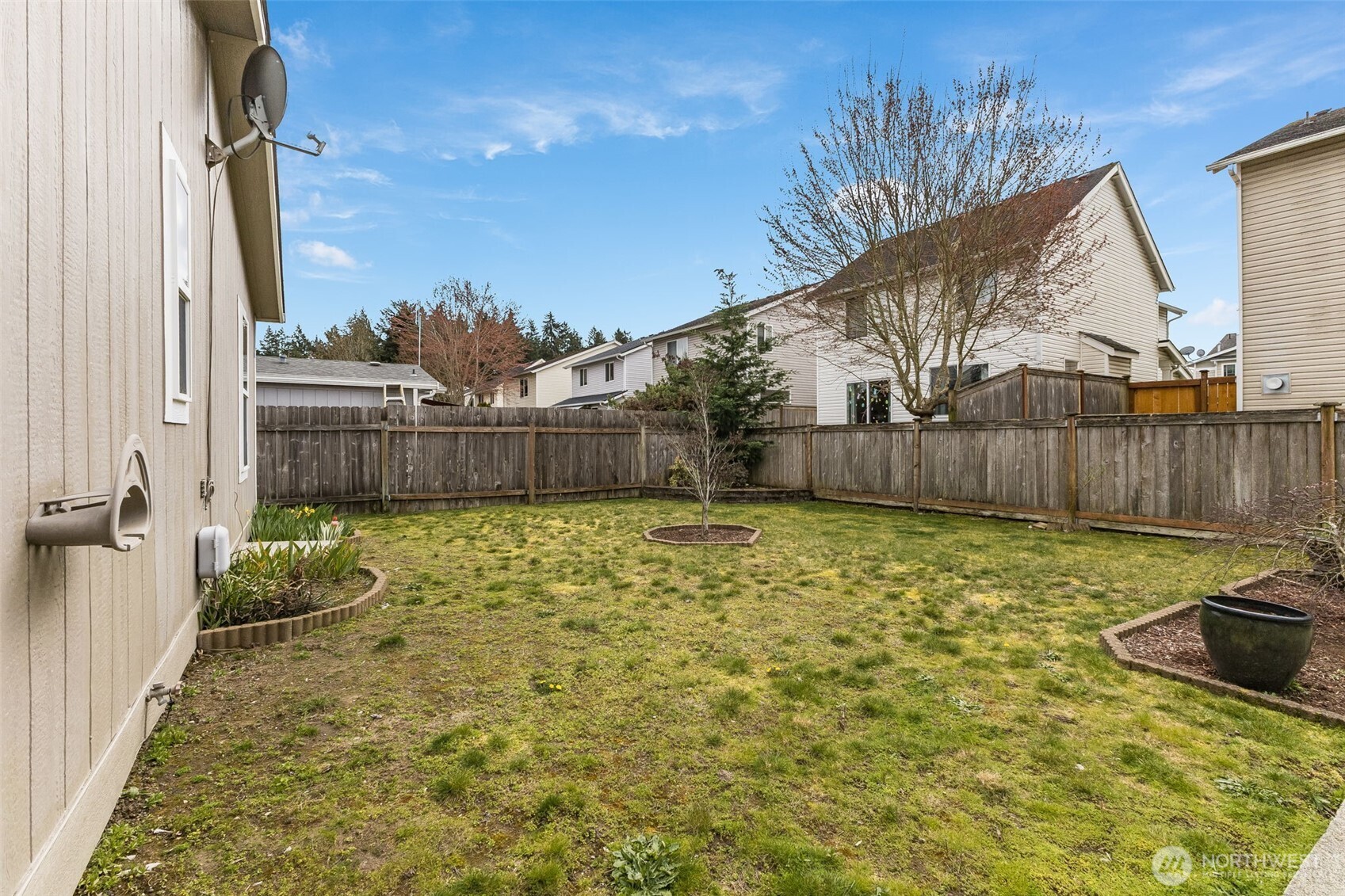 10420 197th Street East Graham, WA 98338 - Photo 20 of 21 a view of a backyard with table and chairs a barbeque and wooden fence