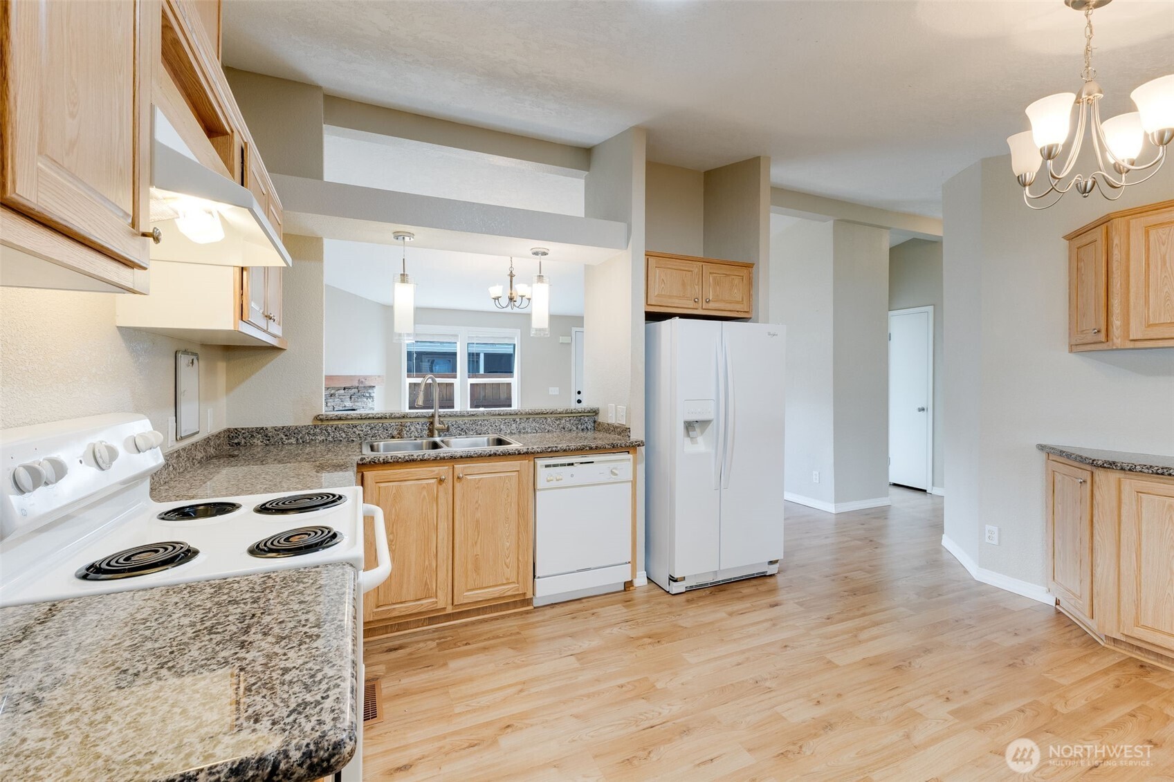 10420 197th Street East Graham, WA 98338 - Photo 3 of 21 a kitchen with stainless steel appliances granite countertop a stove a sink and a refrigerator