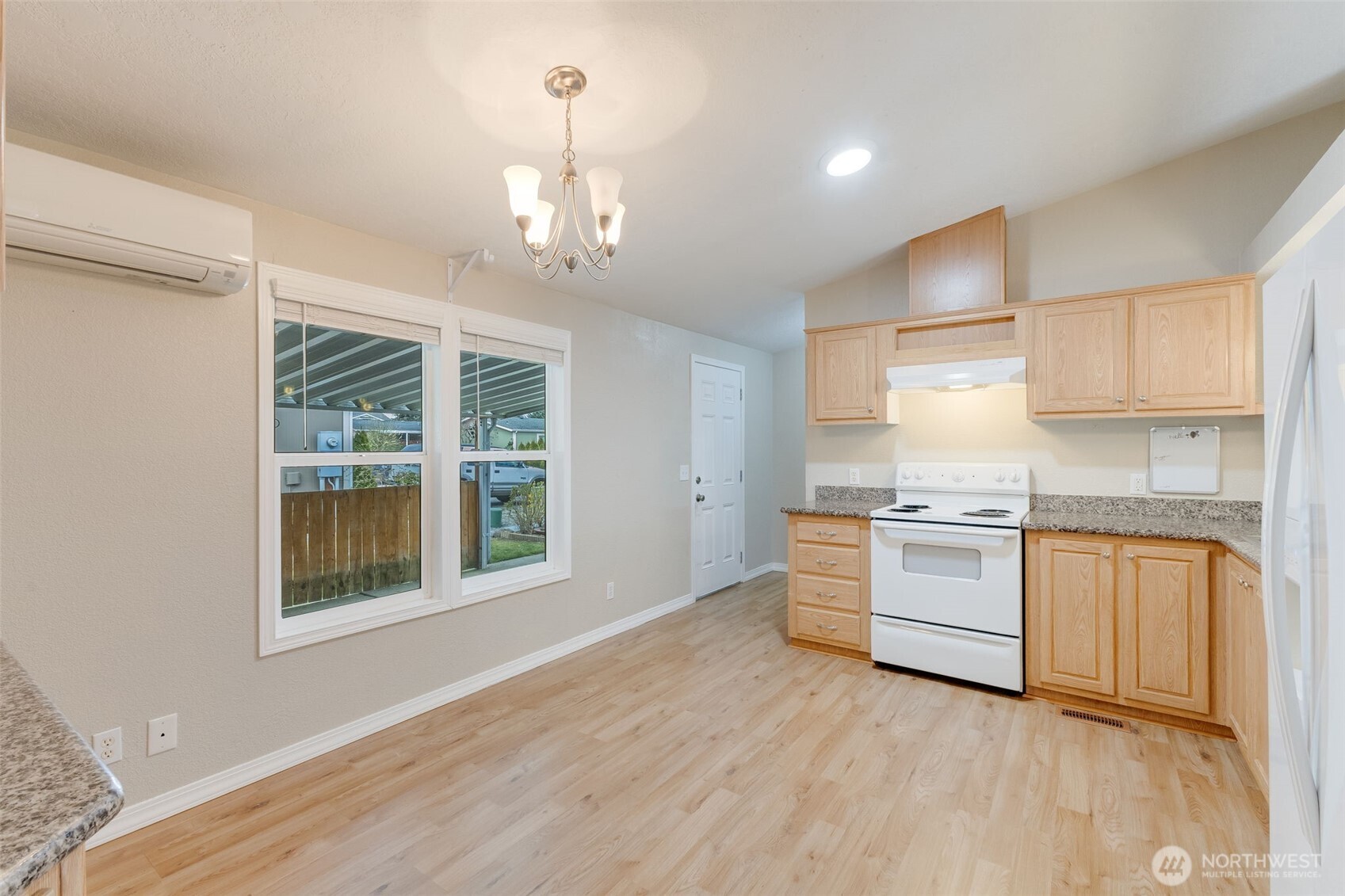 10420 197th Street East Graham, WA 98338 - Photo 4 of 21 a kitchen with granite countertop white cabinets and white appliances