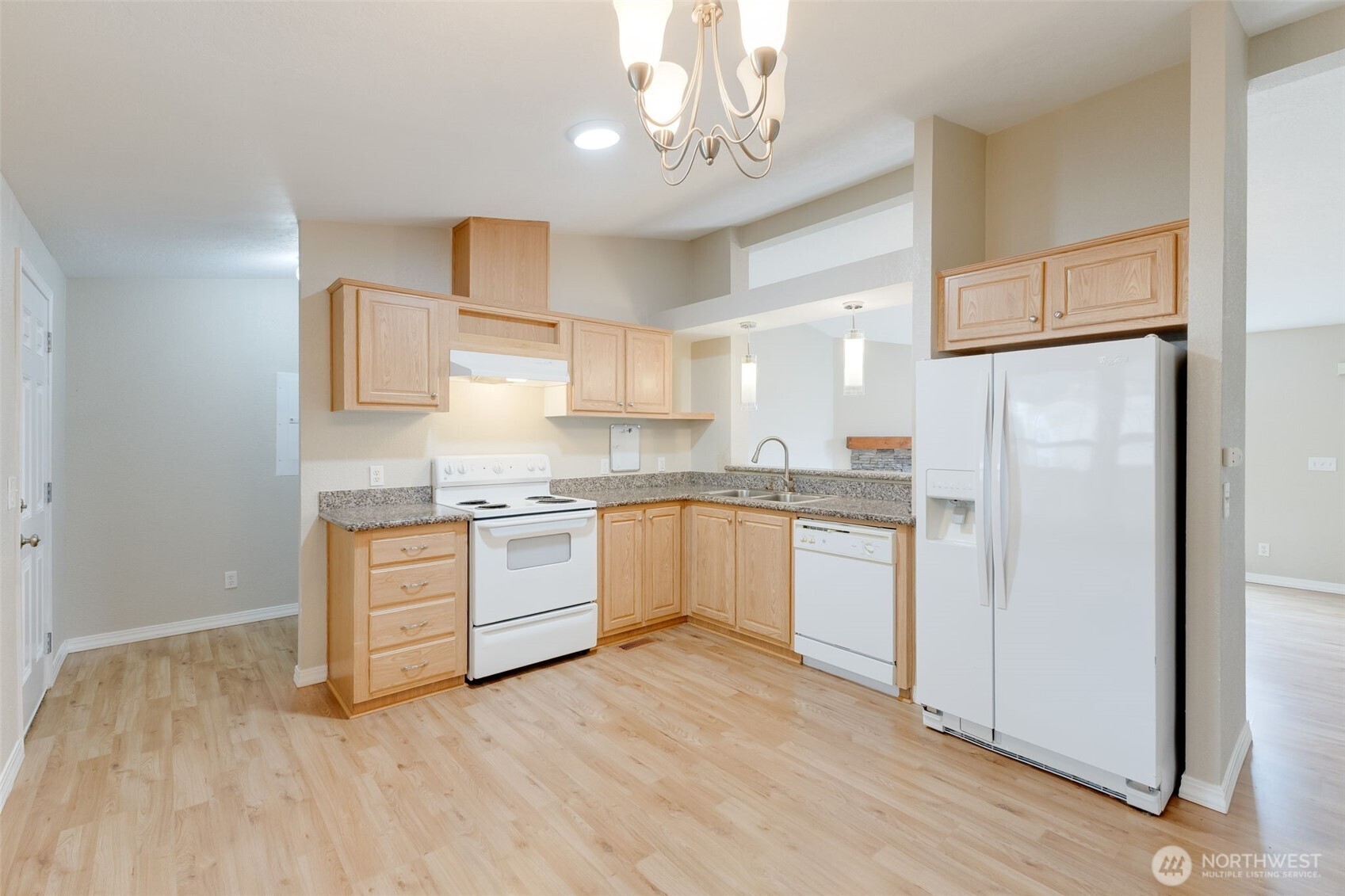 10420 197th Street East Graham, WA 98338 - Photo 5 of 21 a kitchen with granite countertop white cabinets and stainless steel appliances