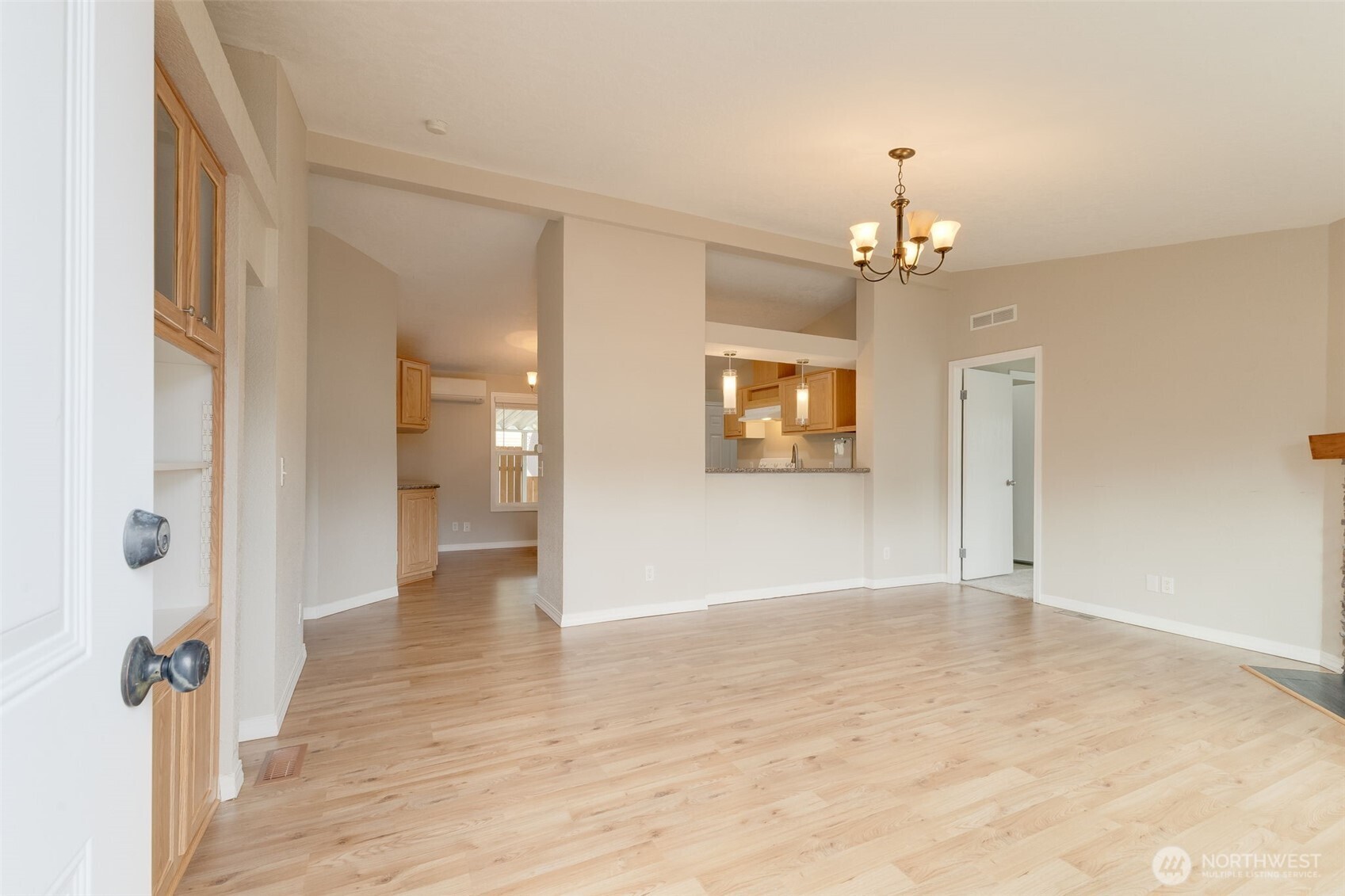 10420 197th Street East Graham, WA 98338 - Photo 8 of 21 a view of a hallway with wooden floor and a bathroom