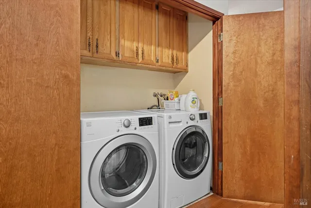 a bedroom with a large bed and a painting on the wall