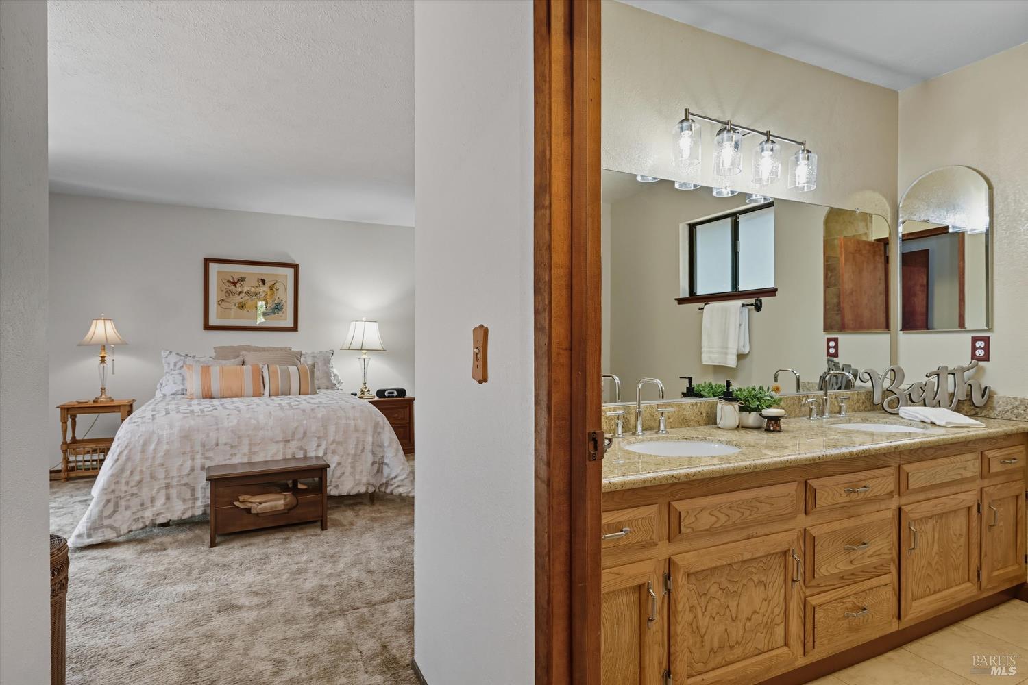 2487 Olivet Road Santa Rosa, CA 95401 - Photo 30 of 48 a en suite bathroom with a double vanity sink and a mirror