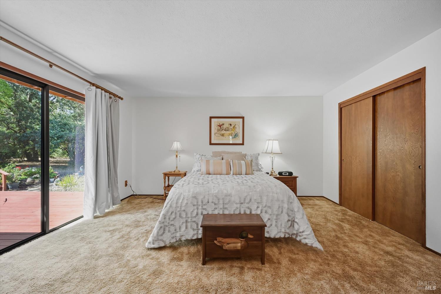 2487 Olivet Road Santa Rosa, CA 95401 - Photo 31 of 48 a bedroom with a large bed and a large window