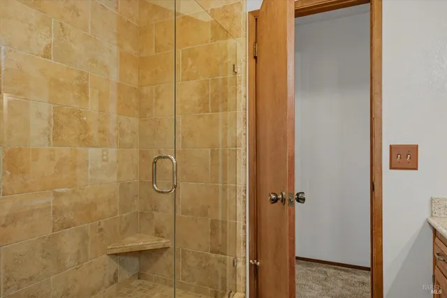 a patio with wooden floor table and chairs