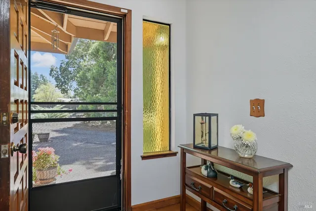 a dining room with furniture a chandelier and window