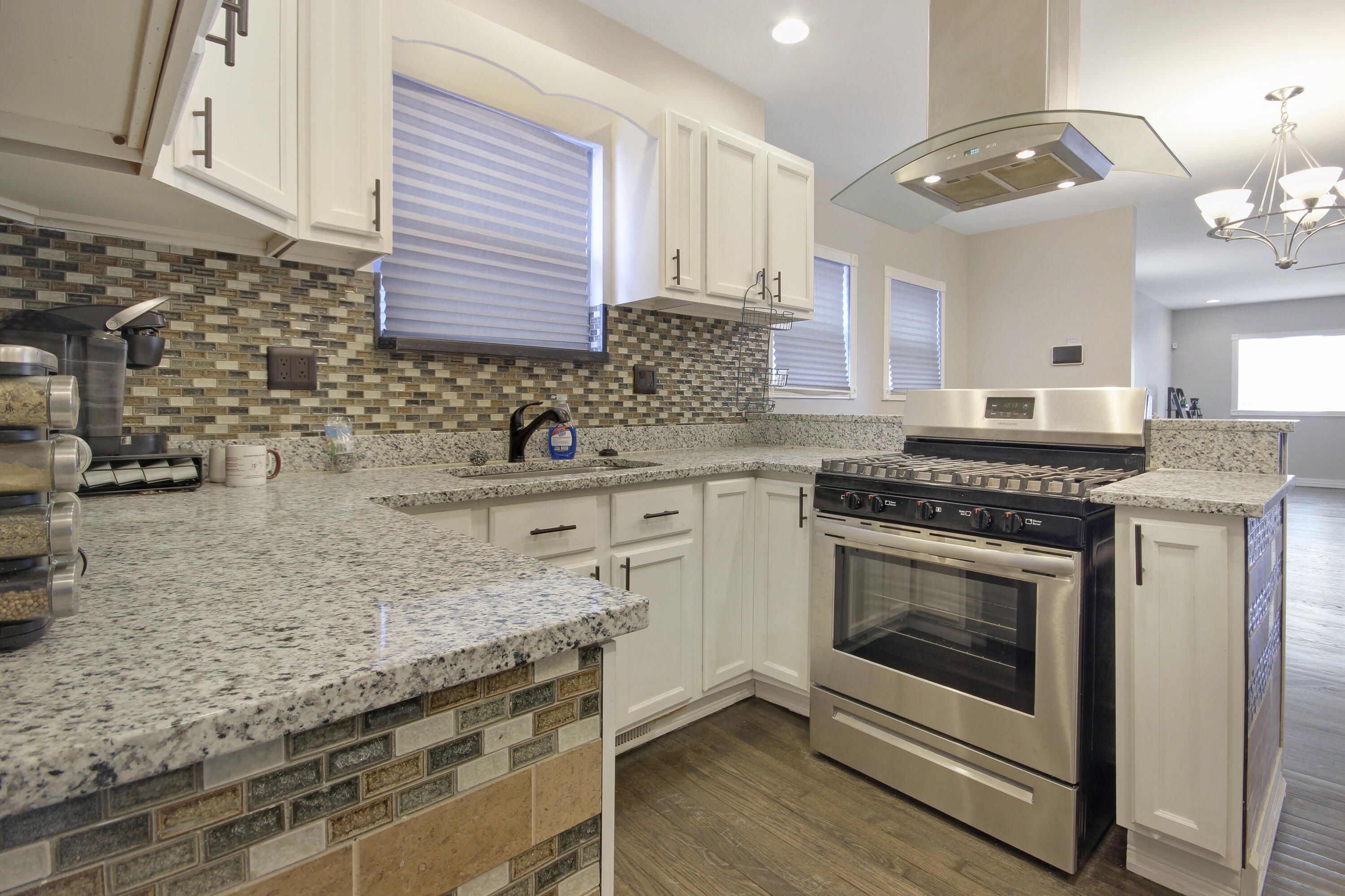 6327 Garfield Avenue Hammond, IN 46324 - Photo 4 of 20 a kitchen with stainless steel appliances granite countertop a stove and a sink