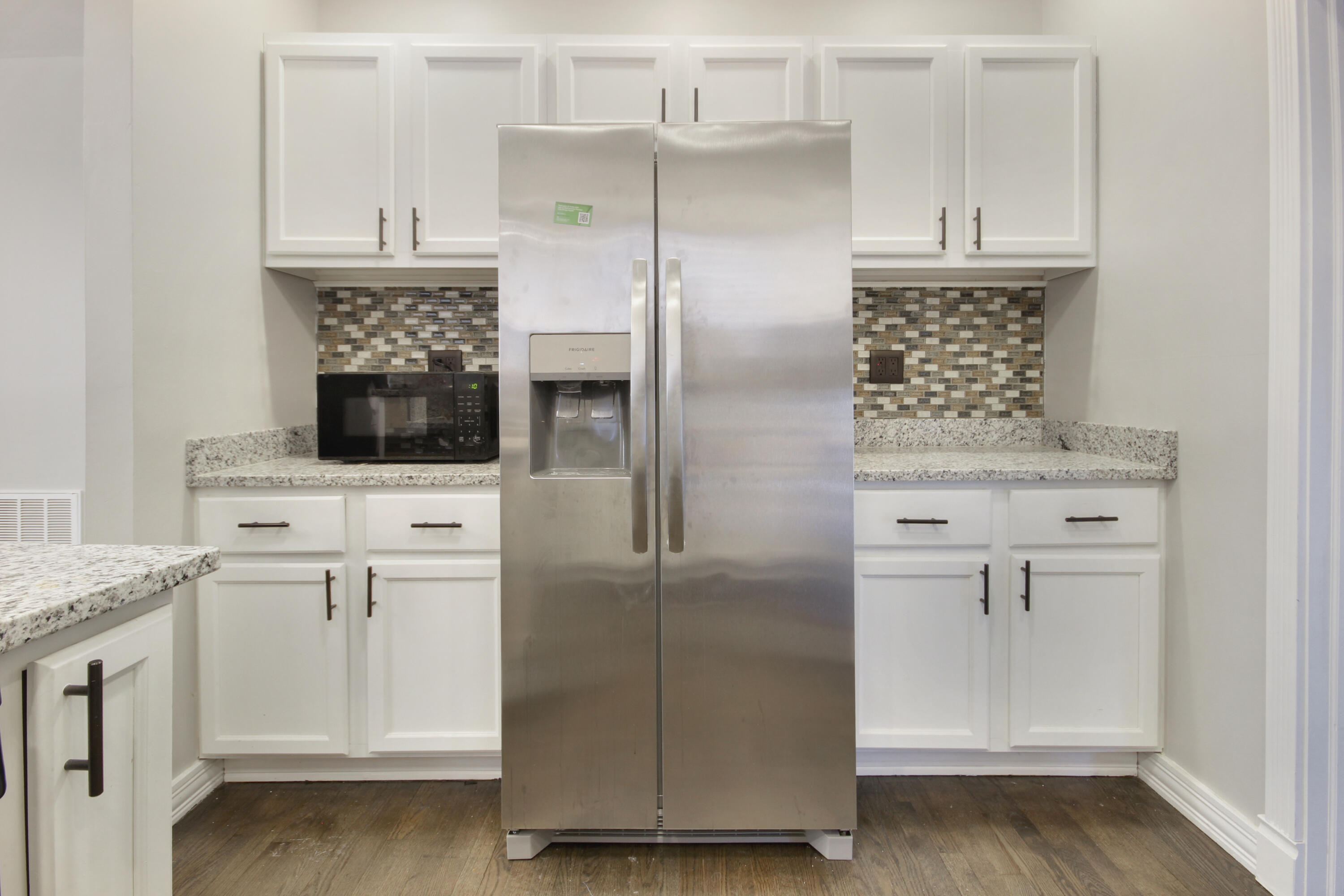 6327 Garfield Avenue Hammond, IN 46324 - Photo 5 of 20 a kitchen with white cabinets and stainless steel appliances