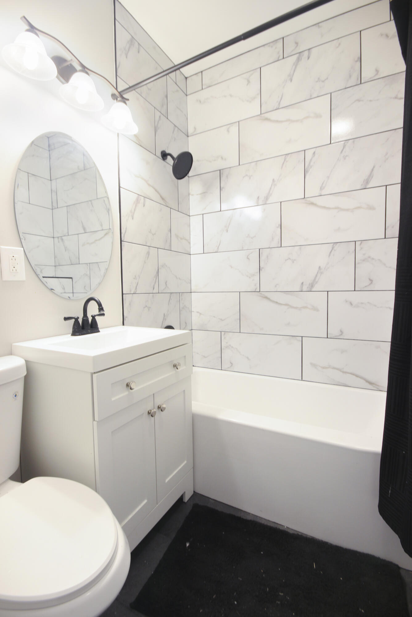 6327 Garfield Avenue Hammond, IN 46324 - Photo 8 of 20 a bathroom with a sink a toilet and bathtub