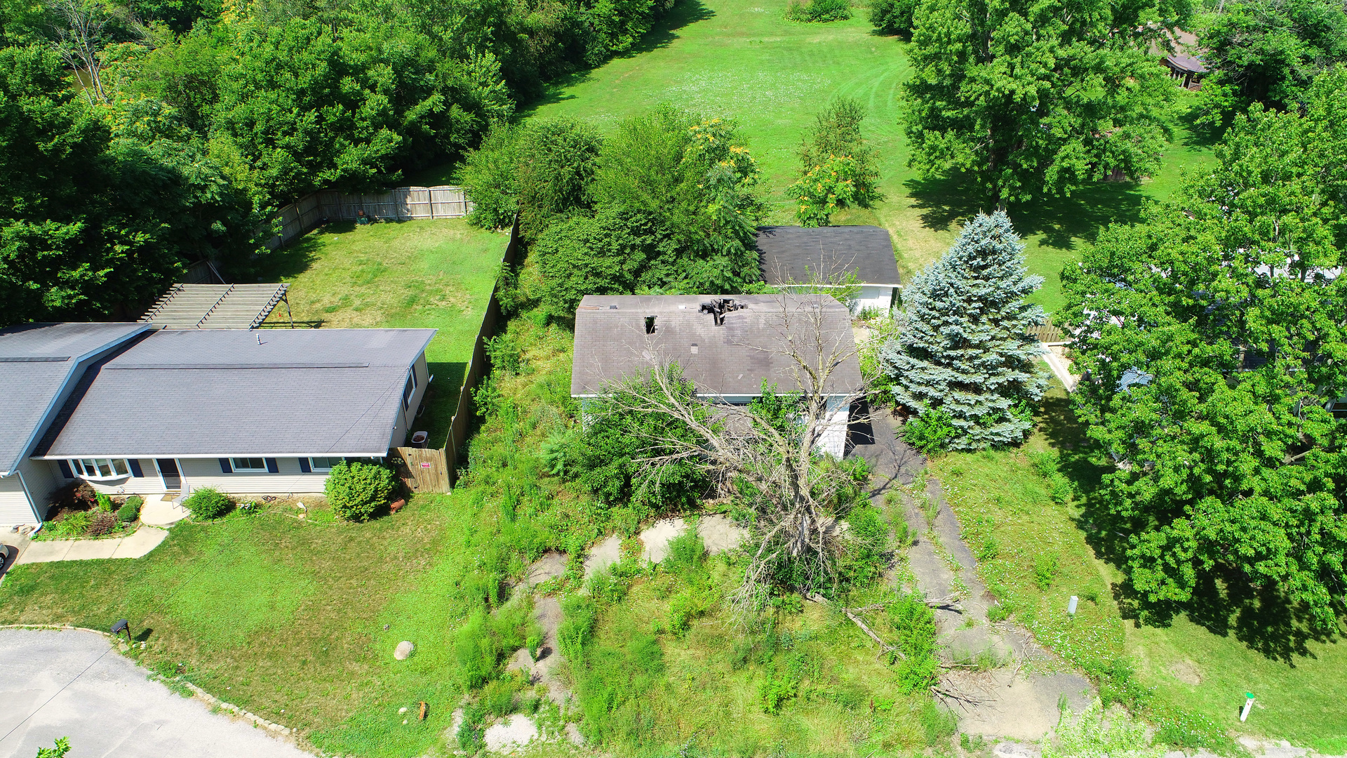 an aerial view of a house with pool garden and outdoor seating