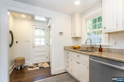 a bathroom with a granite countertop toilet sink and mirror