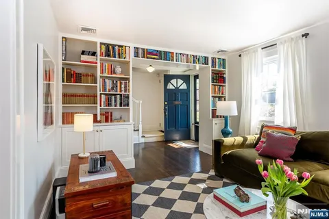 a living room with furniture a rug and a fireplace