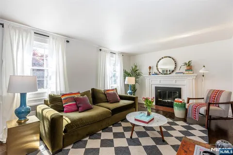 a living room with furniture a rug and a fireplace