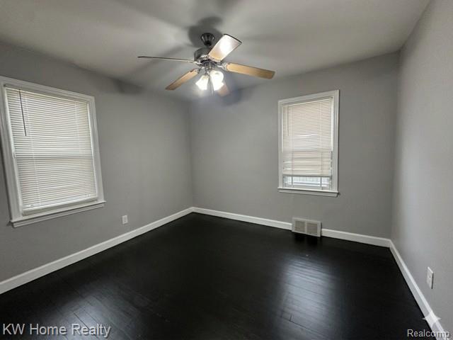 4607 Cadieux Road Detroit, MI 48224 - Photo 6 of 18 Empty room featuring dark wood finished floors and ceiling fan