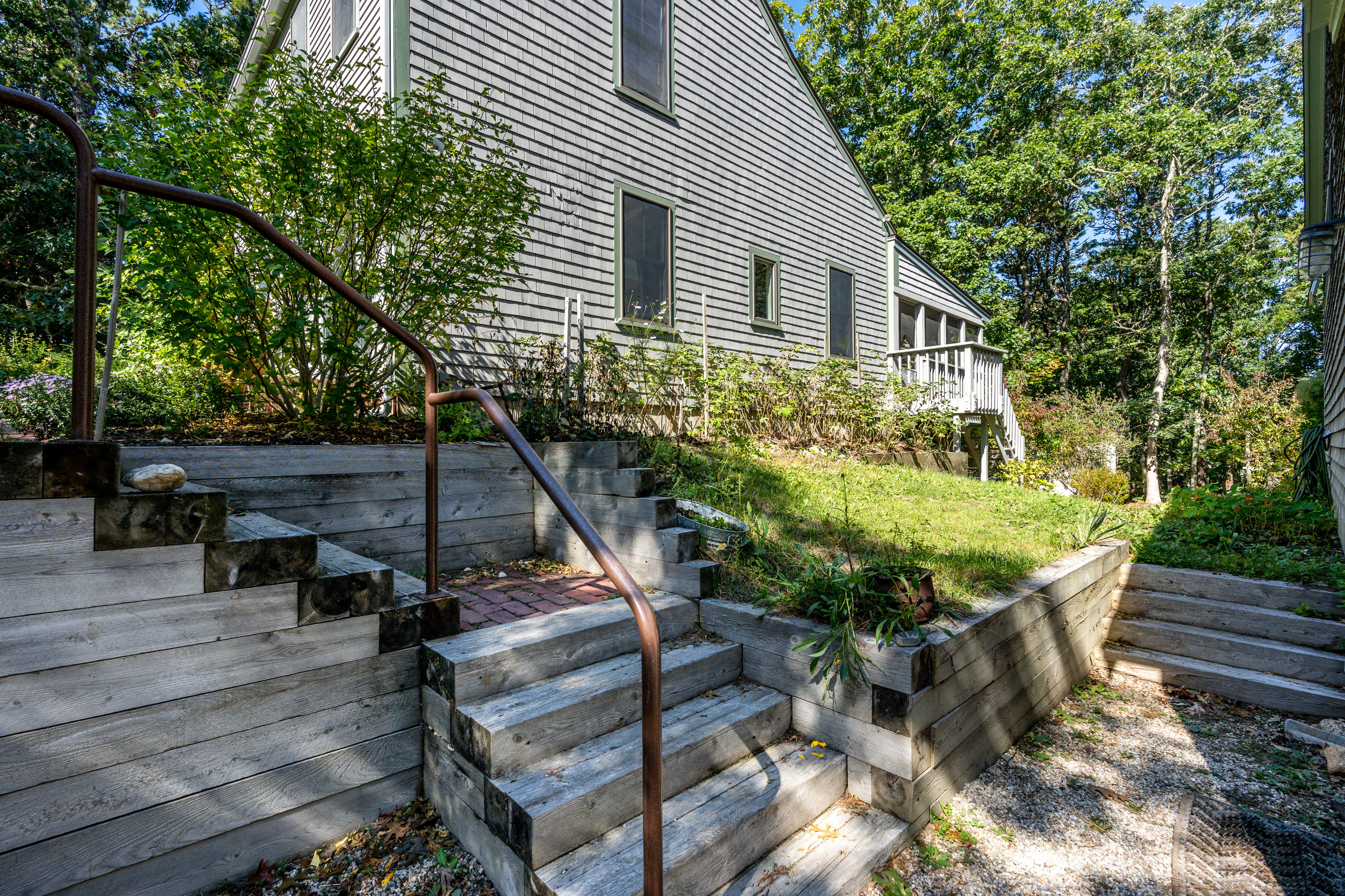 16 Meadow View Wellfleet, MA 02667 - Photo 3 of 36 a backyard of a house with seating space and trees