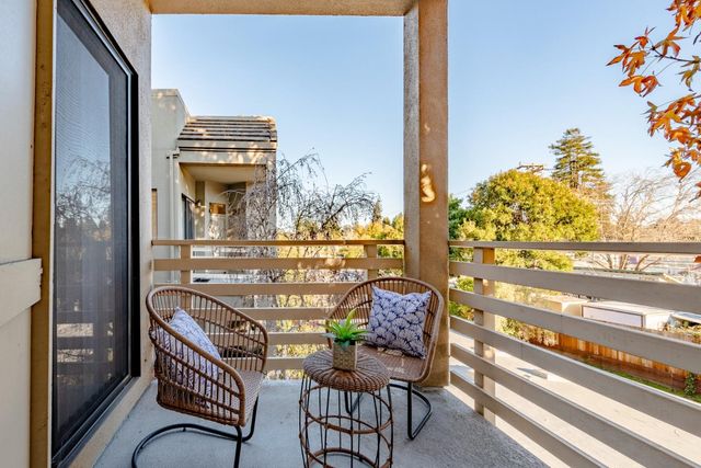 a balcony with table and chairs