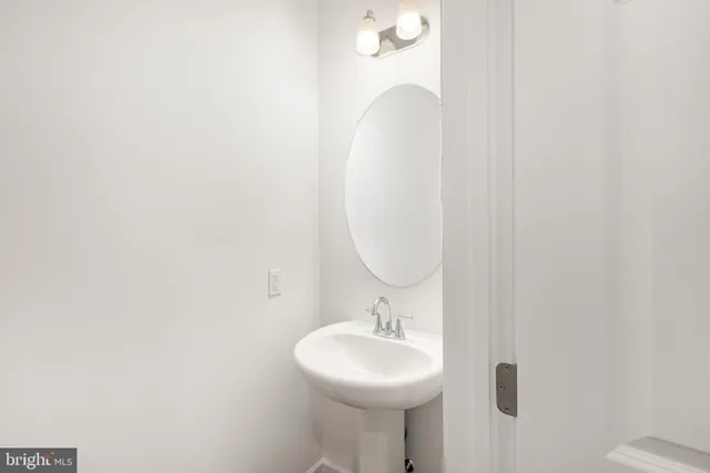 a bathroom with a sink a mirror and toilet