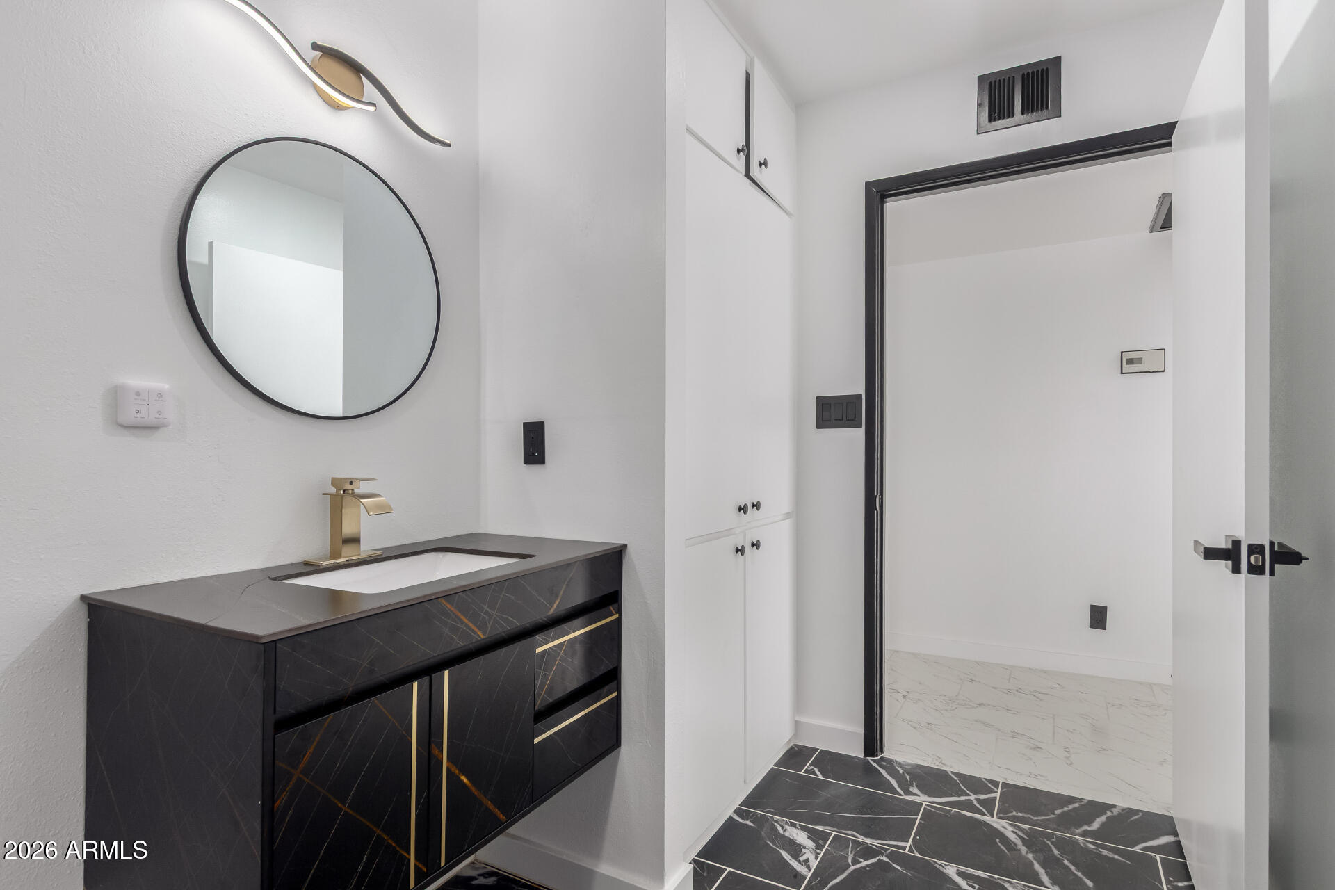 3001 West Ocotillo Road Phoenix, AZ 85017 - Photo 31 of 42 a bathroom with a sink and a mirror