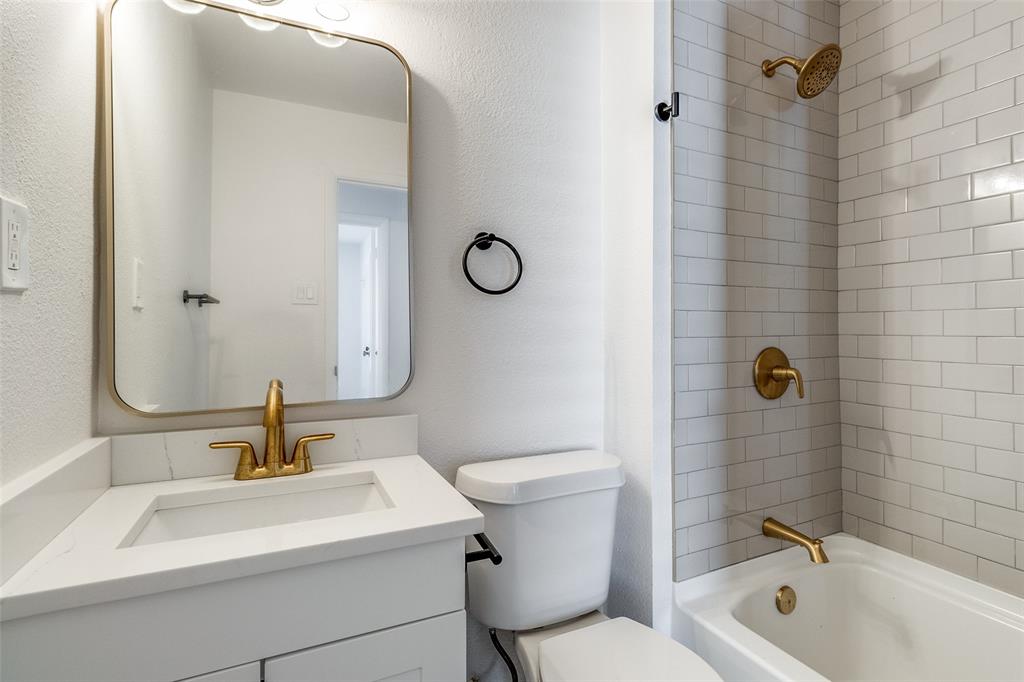 2351 Healey Drive Dallas, TX 75228 - Photo 11 of 12 a bathroom with a sink a toilet and shower