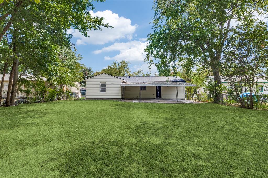 2351 Healey Drive Dallas, TX 75228 - Photo 12 of 12 a view of a house with backyard and garden