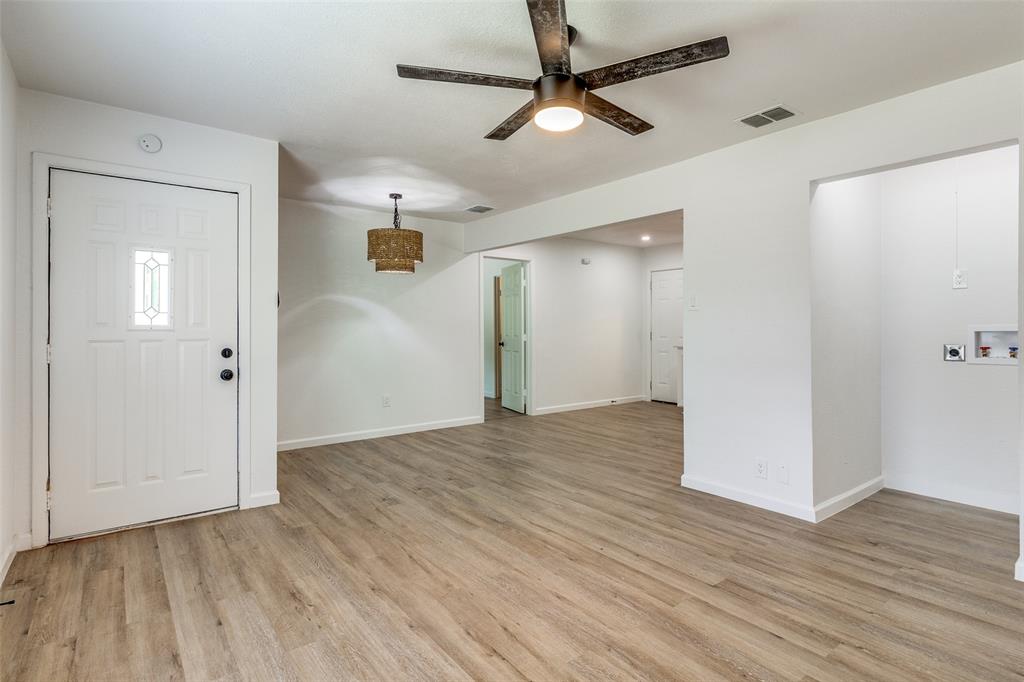 2351 Healey Drive Dallas, TX 75228 - Photo 2 of 12 wooden floor in an empty room with a window