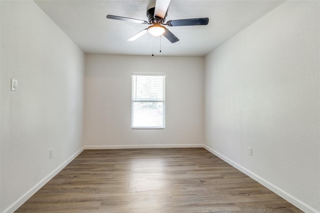 2351 Healey Drive Dallas, TX 75228 - Photo 6 of 12 wooden floor in an empty room with a window