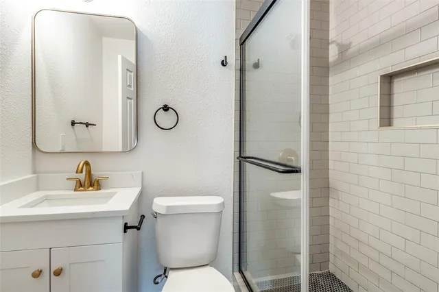 a bathroom with a toilet sink and shower