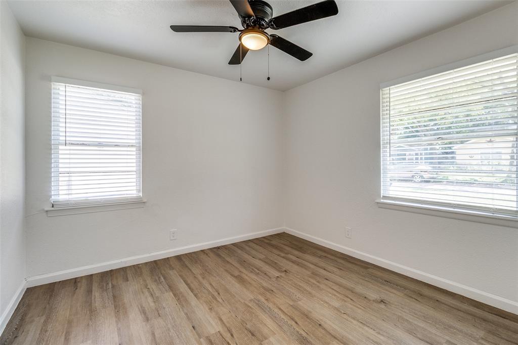 2351 Healey Drive Dallas, TX 75228 - Photo 8 of 12 a view of empty room with wooden floor and fan