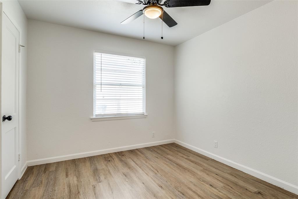 2351 Healey Drive Dallas, TX 75228 - Photo 9 of 12 wooden floor in an empty room with a window
