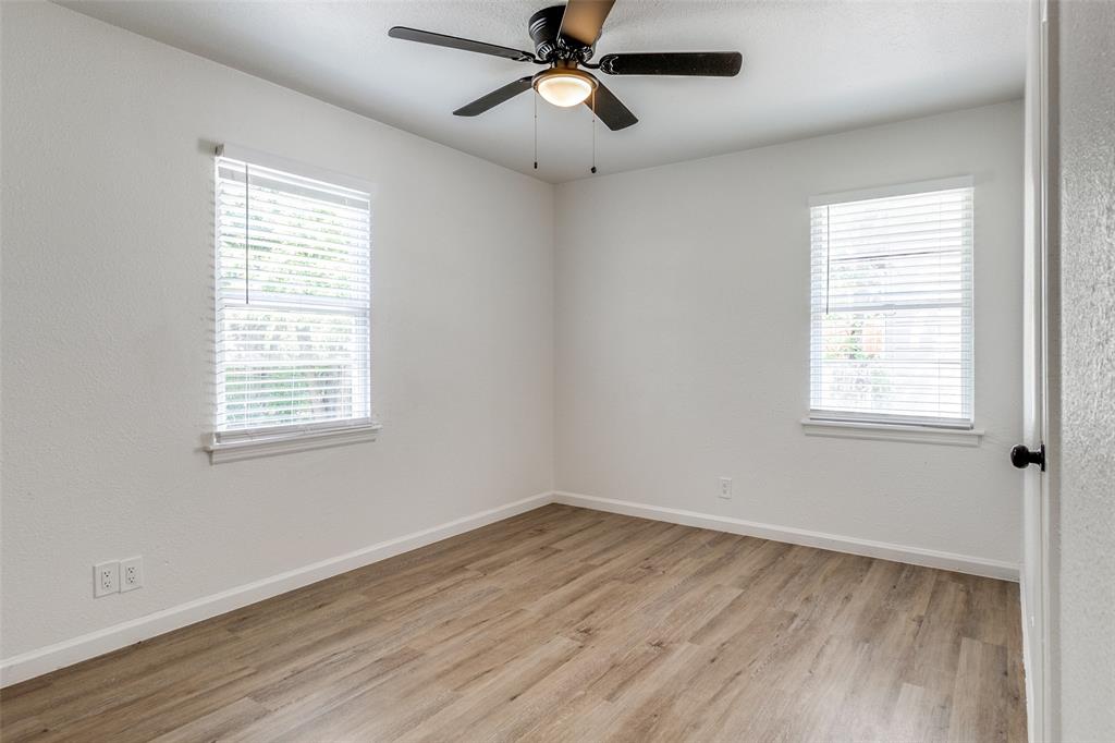 2351 Healey Drive Dallas, TX 75228 - Photo 10 of 12 a view of empty room with wooden floor and fan