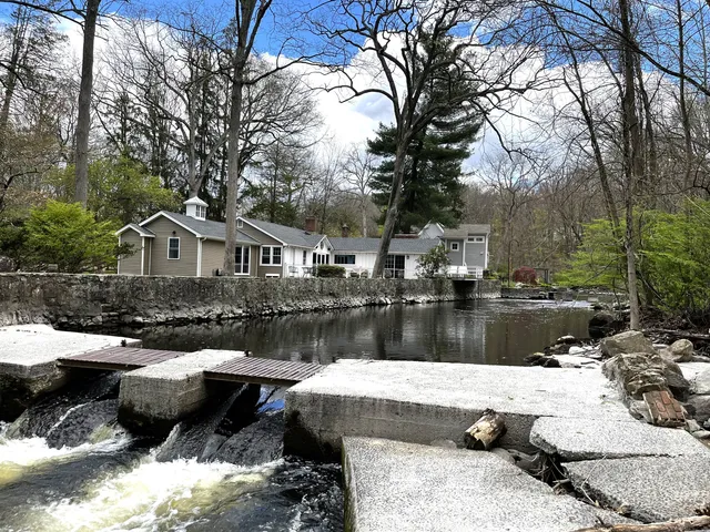 a view of backyard of house with outdoor seating