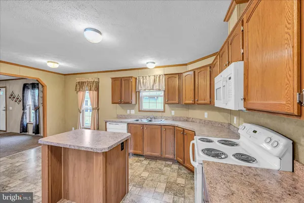 a kitchen with stainless steel appliances granite countertop a refrigerator and stove