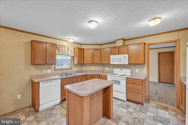 a kitchen with a refrigerator and a sink