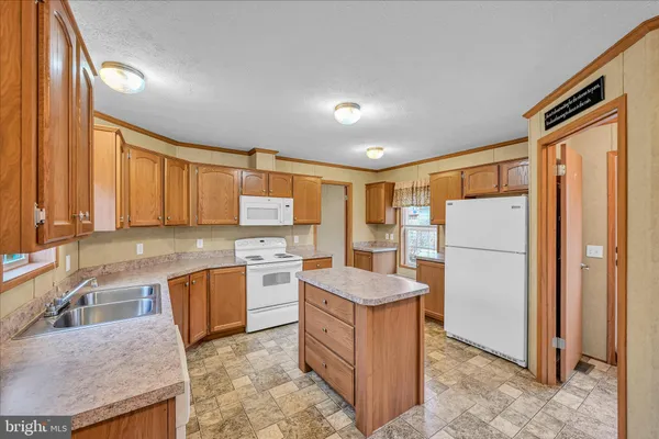 a kitchen with a sink a stove and cabinets