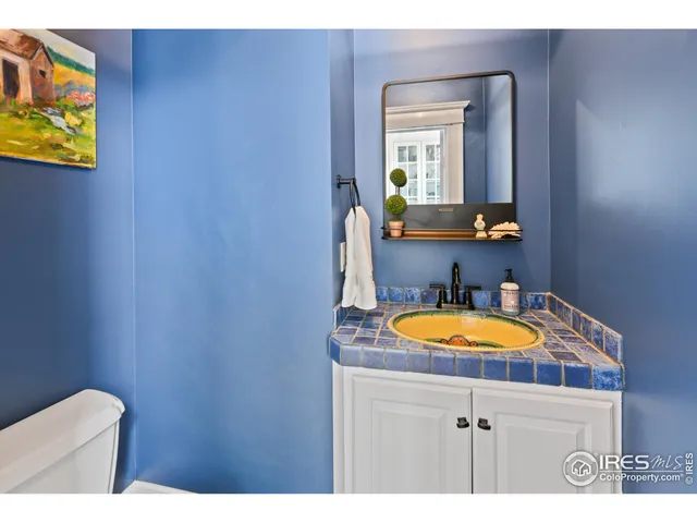 a living room with furniture a rug and white walls