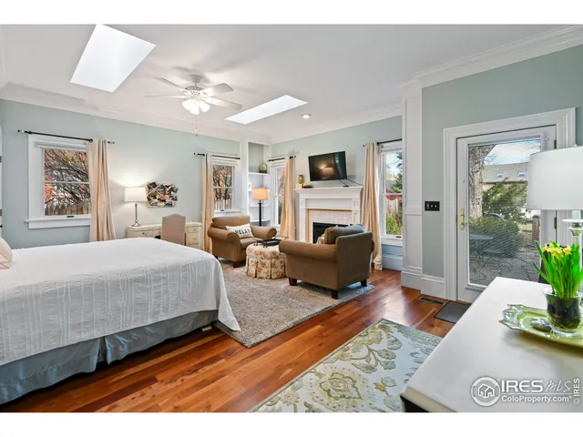 a backyard of a house with a garden and outdoor seating