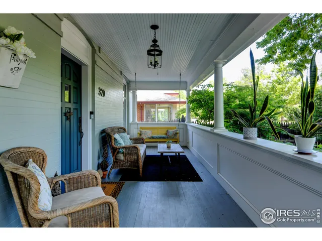 a hallway with furniture and a potted plant