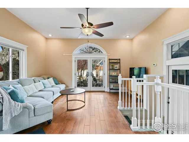a living room with furniture a ceiling fan and a rug