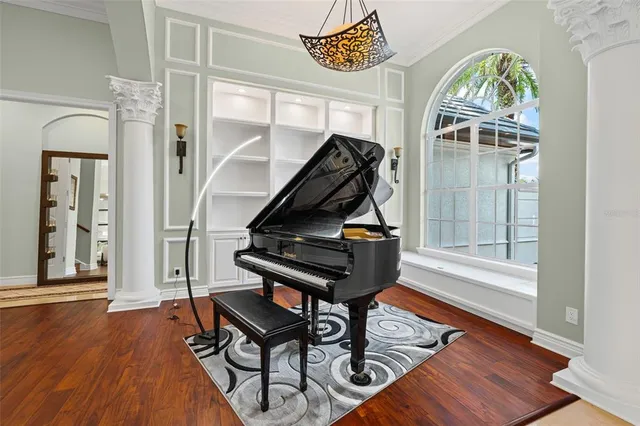 a living room with furniture a fireplace and wooden floor