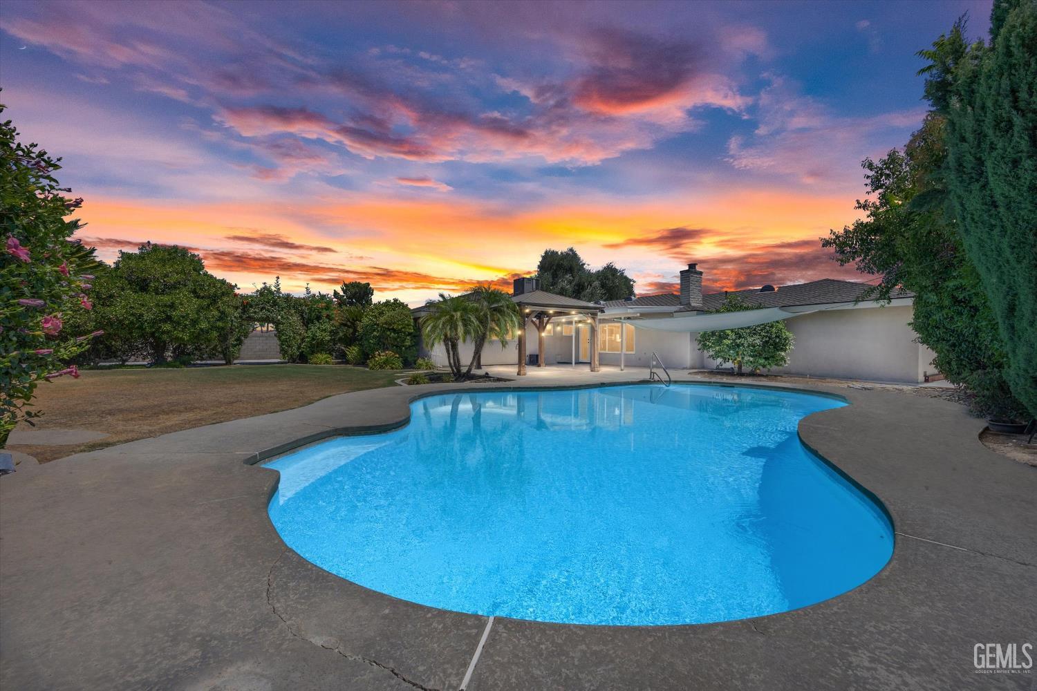 Undisclosed Address Bakersfield, CA 93308 - Photo 13 of 50 a view of a swimming pool with a yard