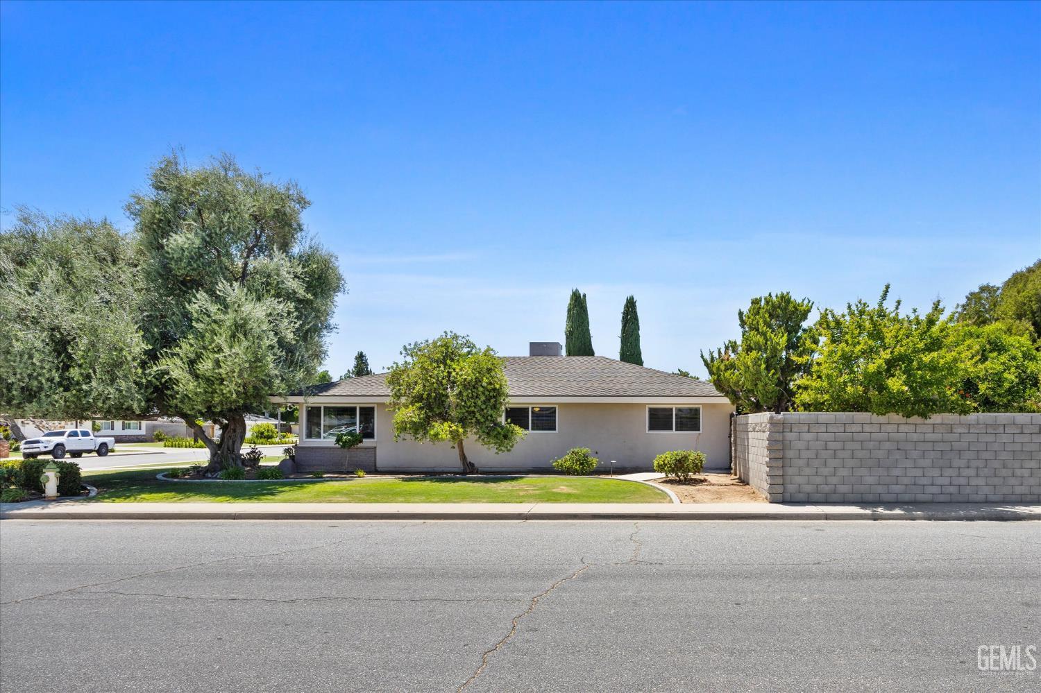 Undisclosed Address Bakersfield, CA 93308 - Photo 19 of 50 a house with trees in front of it