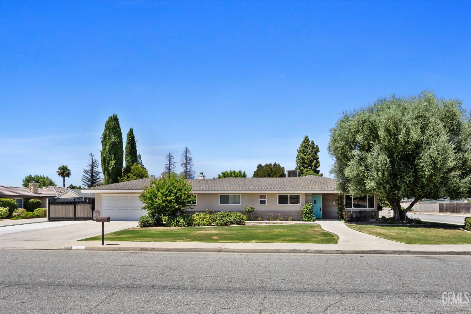 Undisclosed Address Bakersfield, CA 93308 - Photo 20 of 50 a front view of a house with a yard and trees