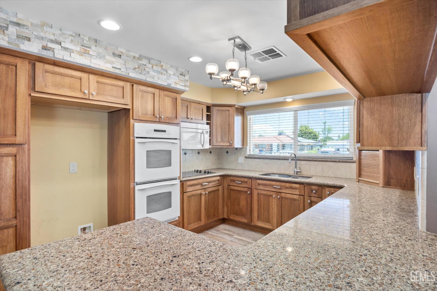 Undisclosed Address Bakersfield, CA 93308 - Photo 29 of 50 a kitchen with stainless steel appliances granite countertop a sink stove and refrigerator