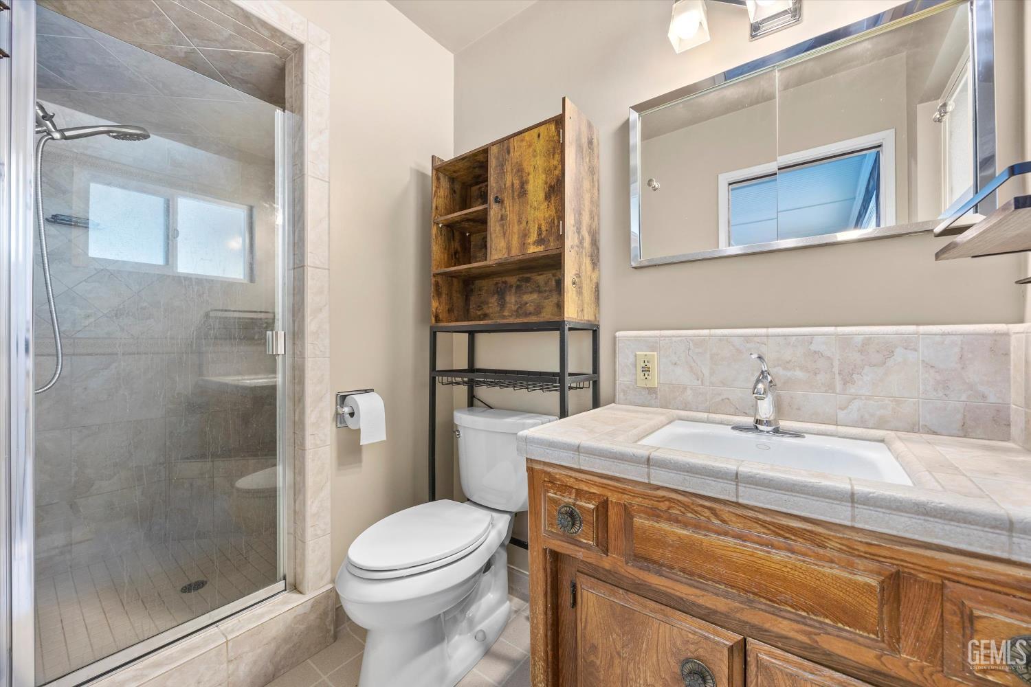 Undisclosed Address Bakersfield, CA 93308 - Photo 41 of 50 a bathroom with a sink toilet and shower