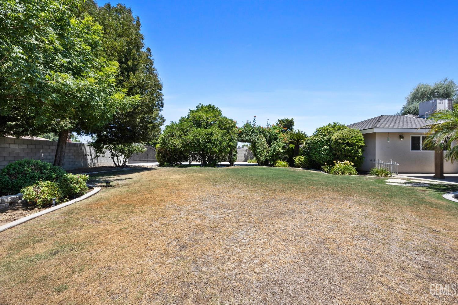 Undisclosed Address Bakersfield, CA 93308 - Photo 47 of 50 a view of backyard of house with green space