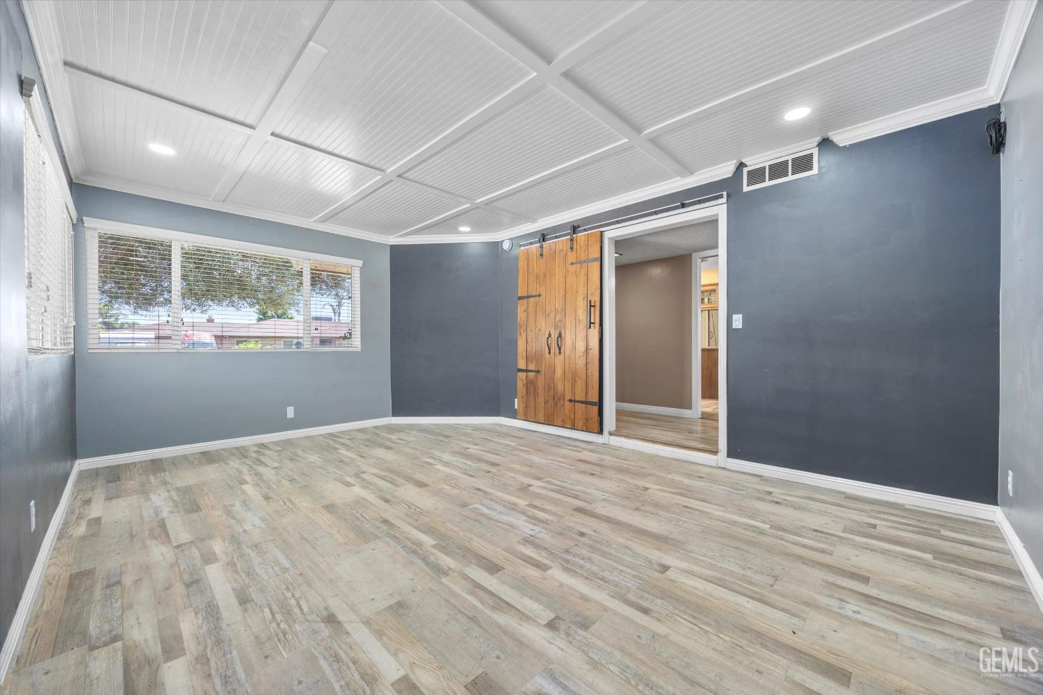 Undisclosed Address Bakersfield, CA 93308 - Photo 7 of 50 a view of empty room with wooden floor and fan