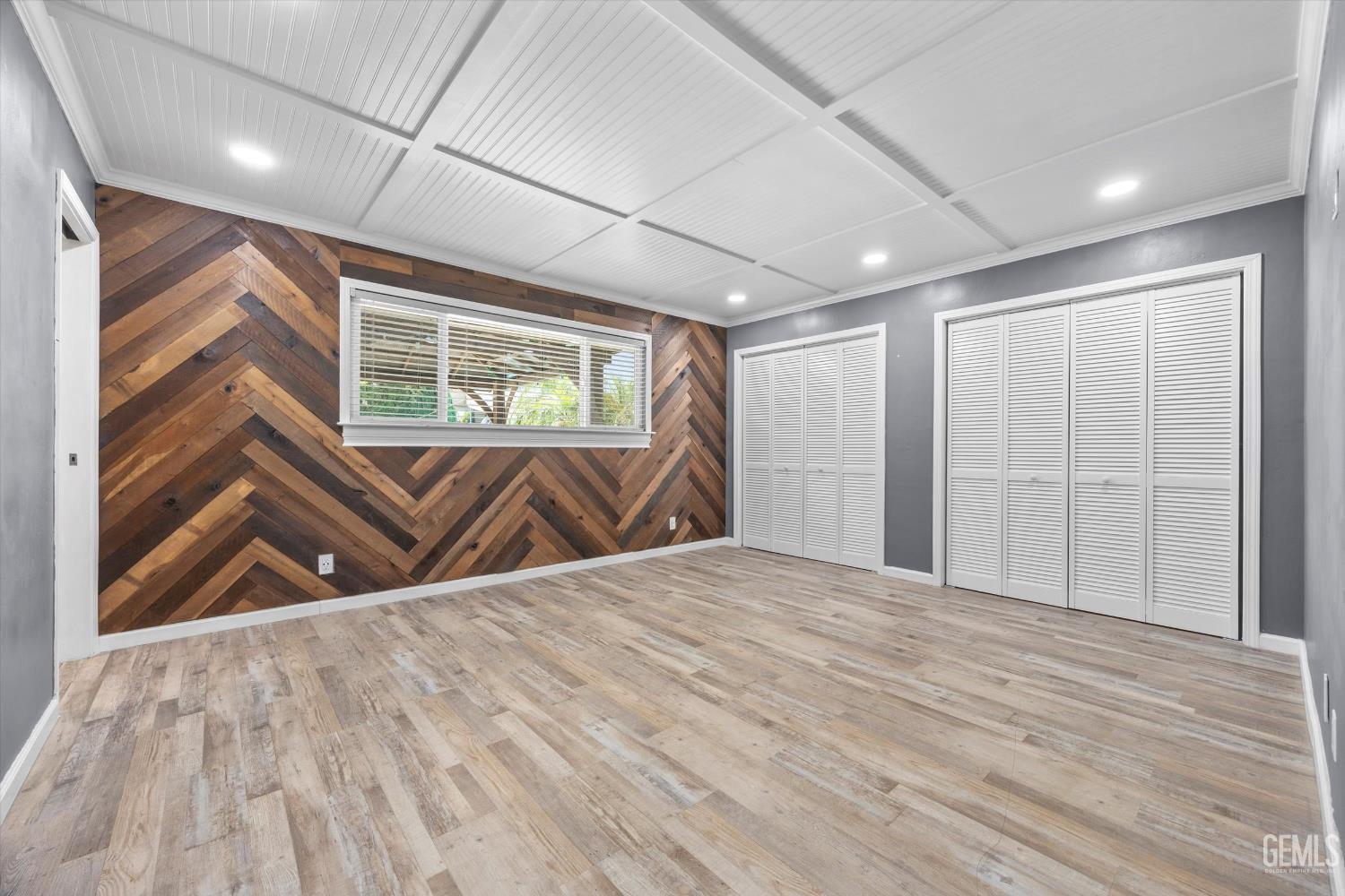 Undisclosed Address Bakersfield, CA 93308 - Photo 9 of 50 a view of an empty room with wooden floor and a window