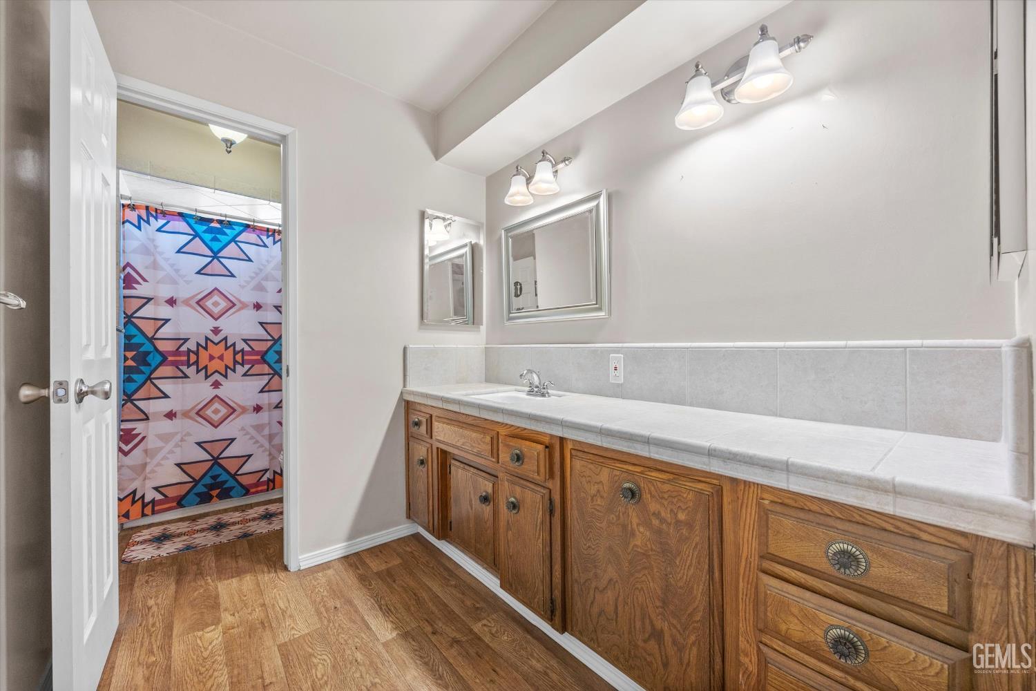 Undisclosed Address Bakersfield, CA 93308 - Photo 10 of 50 a bathroom with a sink a vanity and a mirror